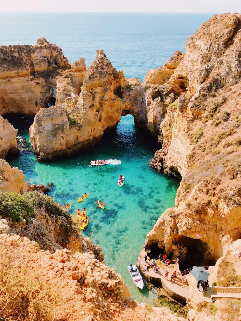 Stunning aerial view of cliffs and clear blue water at Lagos, Portugal, showcasing natural beauty.