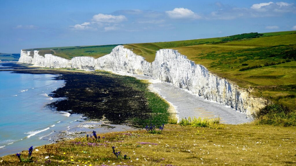 Scenic view of the iconic white cliffs of Seven Sisters, Sussex, with a tranquil seascape.